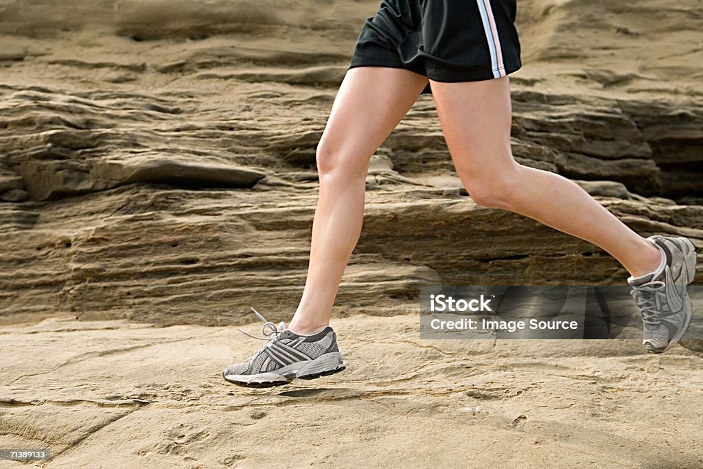 Woman running on rocks  Healthy Lifestyle Stock Photo