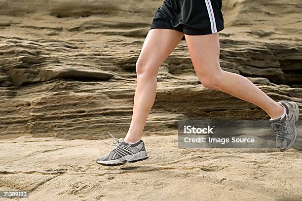 Woman Running On Rocks Stock Photo - Download Image Now - Healthy Lifestyle, Adults Only, Color Image