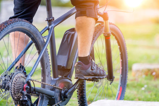 istock Low Section Of Man Riding Bicycle 717241189