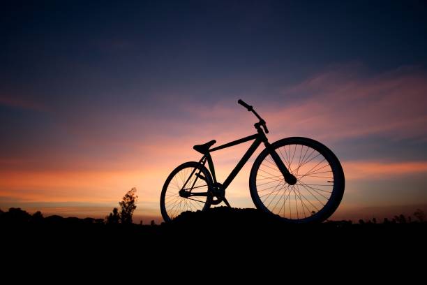 istock Silhouette Of Bicycle Against Sky During Sunset 717367115