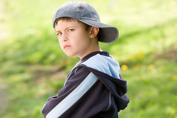 Sulking boy on field  back to front stock pictures, royalty-free photos & images