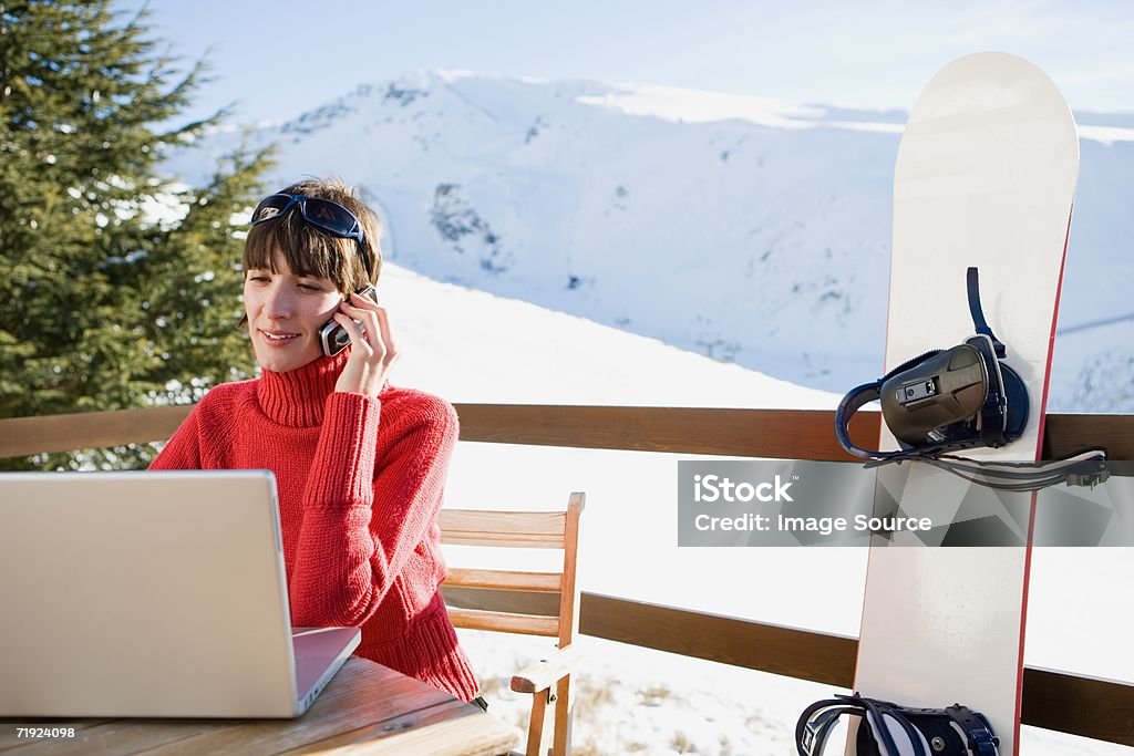 Snowboarder using laptop  Laptop Stock Photo