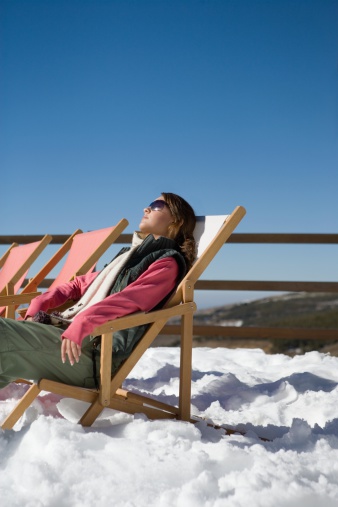 Skiers enjoy the beautiful weather in a deck chair in the ski resort of Serfaus, Fiss, Ladis (Tyrol, Austria)