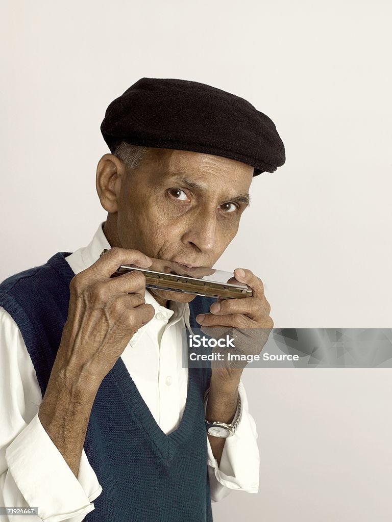 Senior man playing the harmonica - Foto stock royalty-free di Armonica a bocca