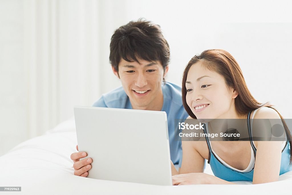 Couple à la recherche à un ordinateur portable - Photo de Adulte libre de droits