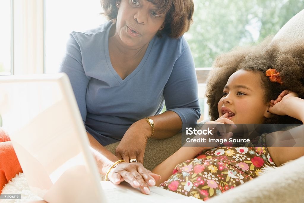 Girl and grandmother with laptop  Adult Stock Photo