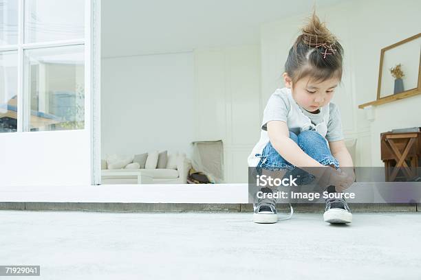 Girl Learning To Tie Her Shoelaces Stock Photo - Download Image Now - Child, Shoe, Tying