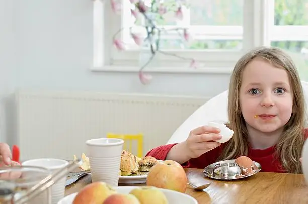 Photo of Girl eating an egg