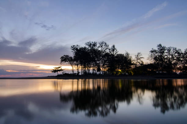 istock Reflection Of Trees In Water Against Sky 720007997