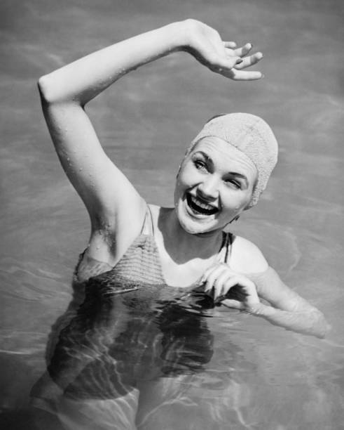 Woman waving in pool (B&W),, elevated view  one piece swimsuit photos stock pictures, royalty-free photos & images