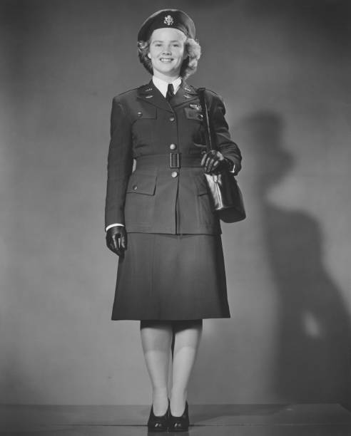 Woman in World War II military uniform posing in studio (B&W), portrait  army soldier photos stock pictures, royalty-free photos & images