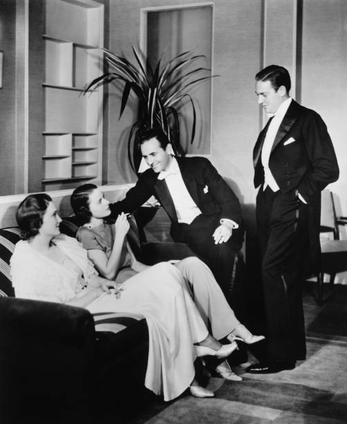 People in evening wear talking in living room (B&W)  tuxedo photos stock pictures, royalty-free photos & images