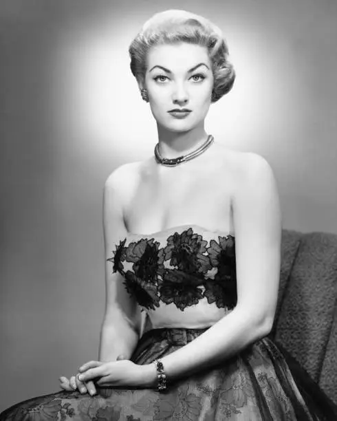 Photo of Woman in evening dress posing in studio (B&W), portrait