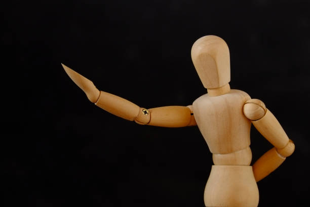 istock Wooden Mannequin Against Black Background 722302451
