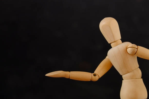 istock Wooden Mannequin Against Black Background 722305263