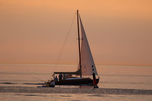 istock Lone Boat In Calm Sea Against Orange Sky 722334835