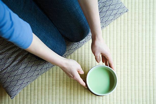 Woman holding bowl of green tea  zabuton stock pictures, royalty-free photos & images