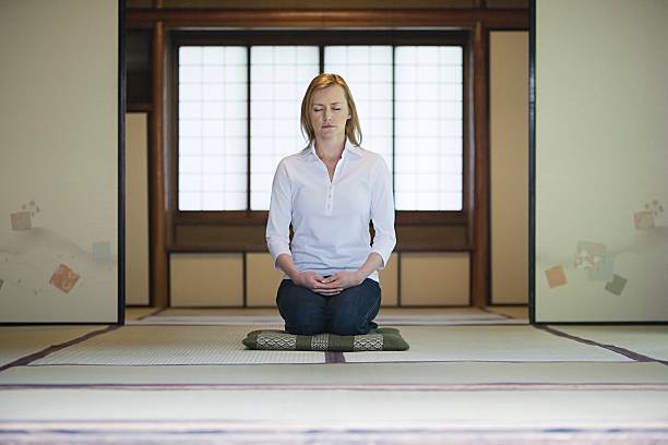 Woman meditating  zabuton stock pictures, royalty-free photos & images