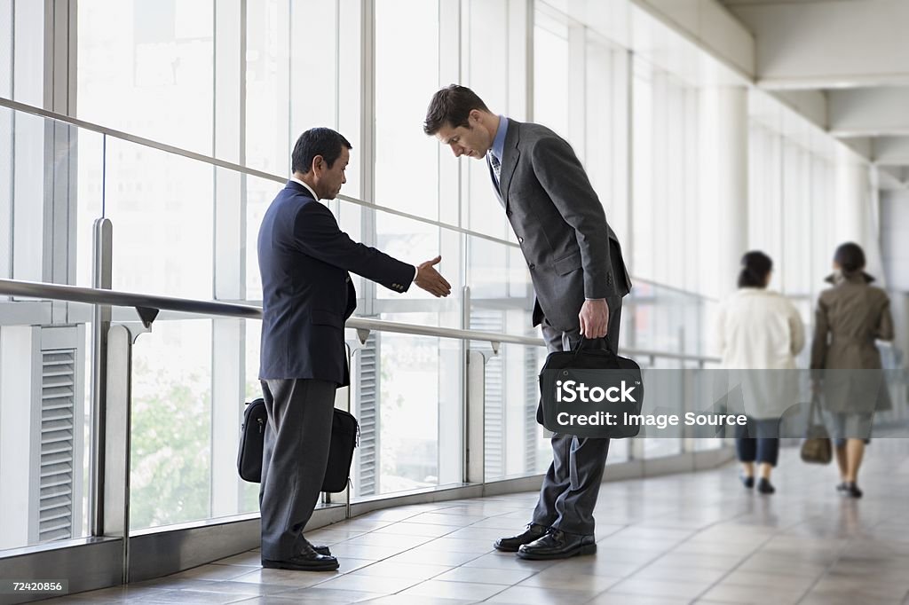 Businessmen greeting  Cultures Stock Photo