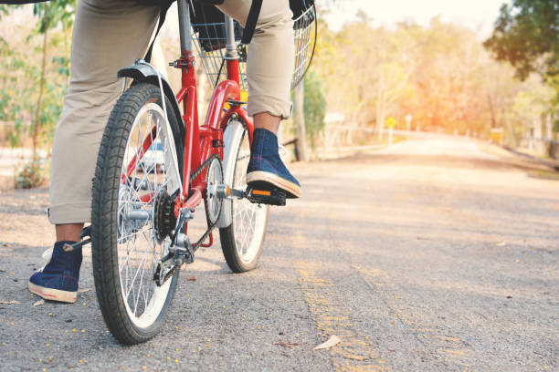 istock Low Section Of Man With Bicycle On Road 724321109