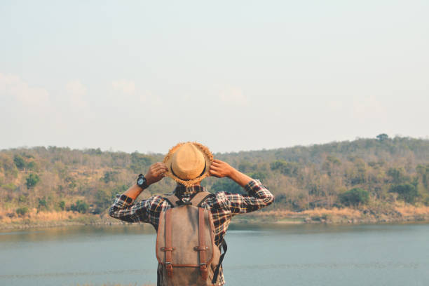 istock Rear View Of Man By Water Against Sky 724321629