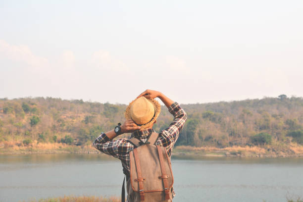 istock Rear View Of Man Standing By Against Sky 724322273