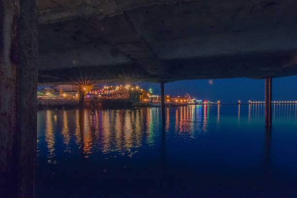 istock Reflection Of Illuminated Bridge In Water At Night 724330901