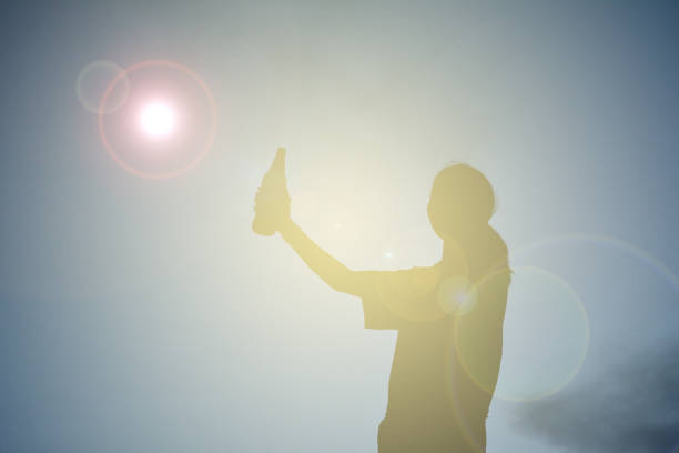 istock Silhouette Woman Holding Bottle Against Sky During Sunset 726847573