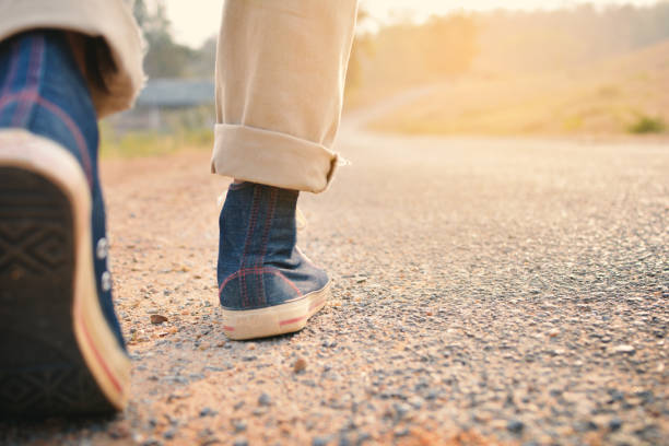 istock Low Section Of Man Walking On Road 726852741