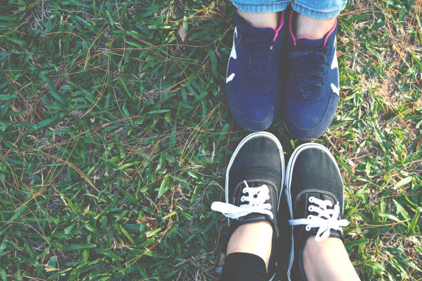 istock Low Section Of Female Friends On Grass At Park 726854193
