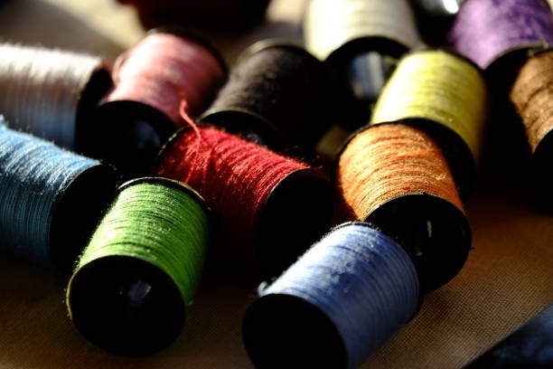 istock Close-Up Of Colorful Spools Of Thread On Fabric 726856673