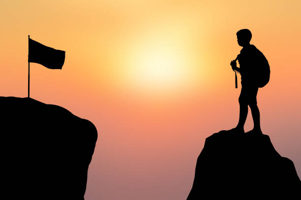 istock Silhouette Boy And Flag On Mountains Against Sky During Sunset 726865659