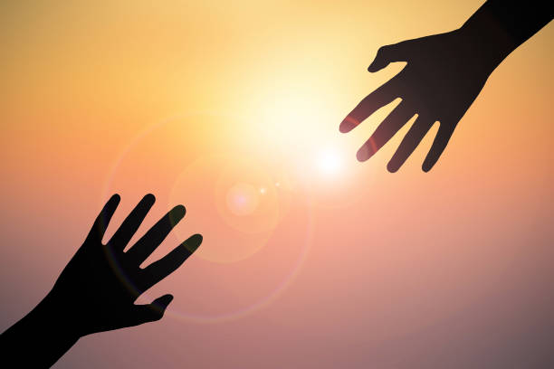 istock Cropped Hands Of People Against Sky During Sunset 726870625