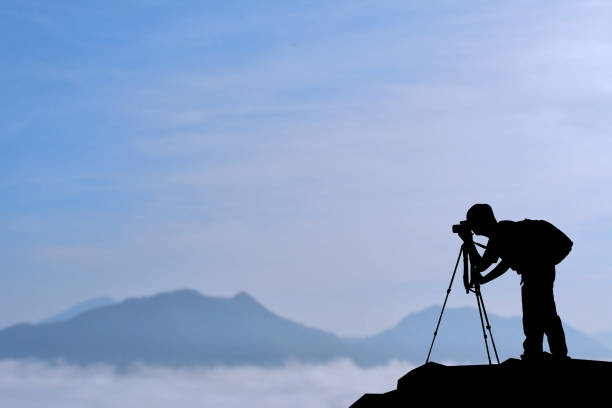 istock Silhouette Man Photographing While Standing On Mountain During Sunset 726871155