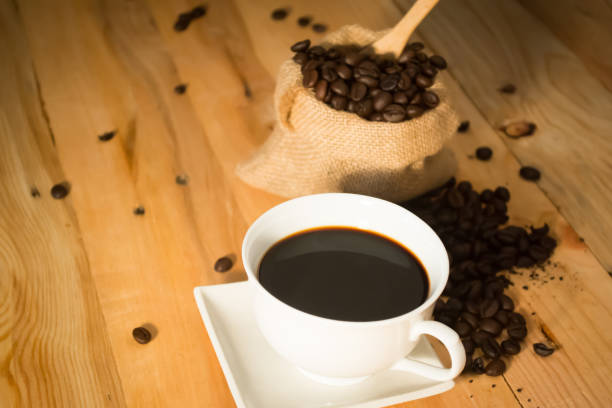 istock Cup By Grinder And Roasted Coffee Beans On Wooden Table 726874259