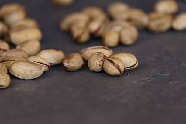 istock Close-Up Of Pistachios On Gray Table 726882507