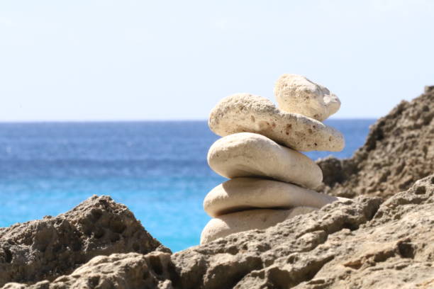 istock Stack Of Rocks By Sea Against Clear Sky 726951165