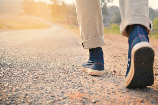 istock Low Section Of Man Walking On Road 727142167
