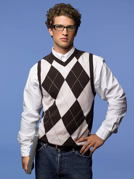 young man holding a laptop computer - sweater vest 뉴스 사진 이미지