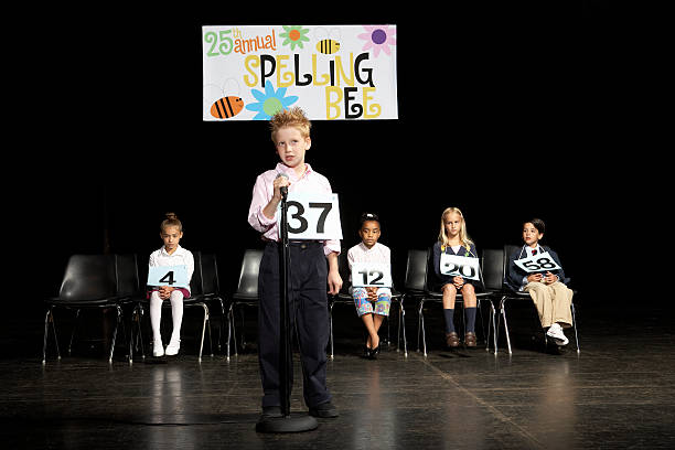 Boy (8-9) at spelling bee competition  spelling bee stock pictures, royalty-free photos & images