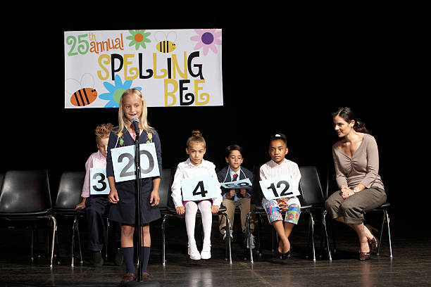 Girl (6-7) performing at spelling bee competition  dv stock pictures, royalty-free photos & images
