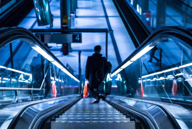 istock Rear View Of Man On Escalator 728920179