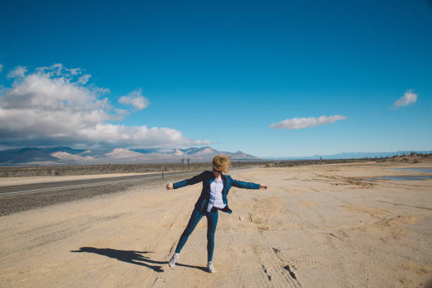 istock Woman Standing On Desert Against Sky 730151231
