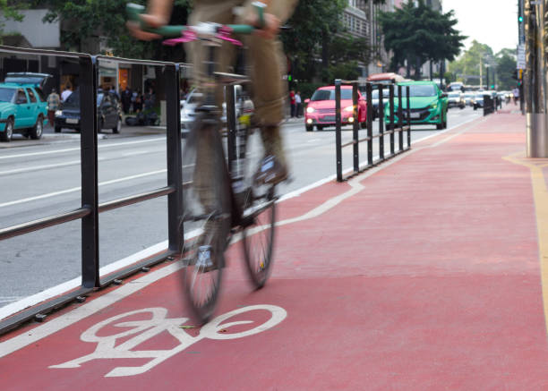 istock Low Section Of Man Riding Bicycle On Road 730259059