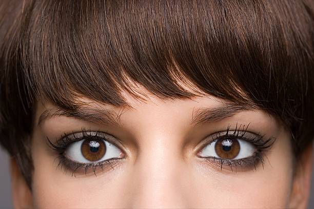 ojos de mujer joven - flequillo fotografías e imágenes de stock