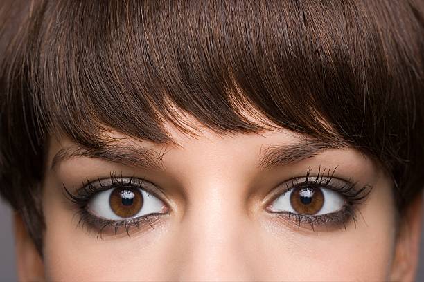 Eyes of a young woman  bangs hair stock pictures, royalty-free photos & images