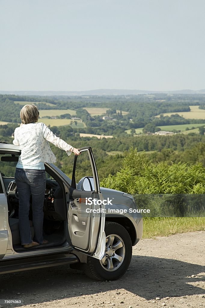 Woman looking at view from her car  Active Seniors Stock Photo