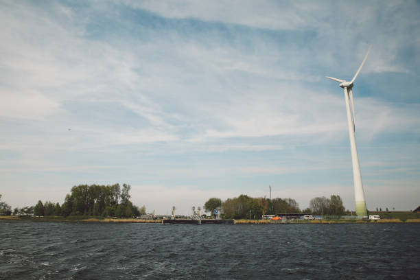 istock Windmills By Lake Against Sky 731843081
