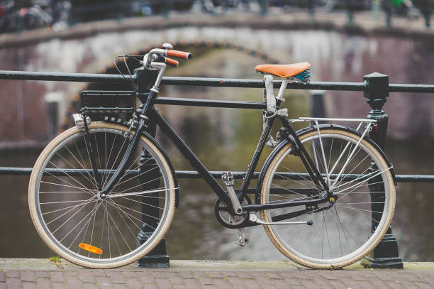 istock Bicycle Parked On Bridge Over Canal 731858953