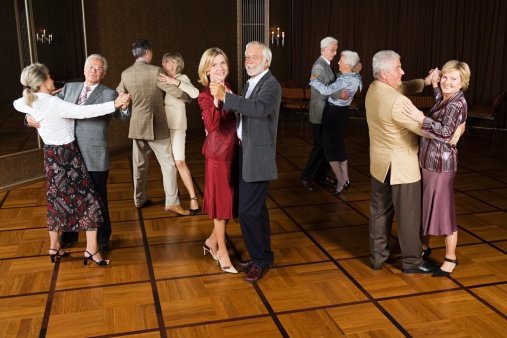 Dancing teacher teaching senior woman at a class in a dance studio